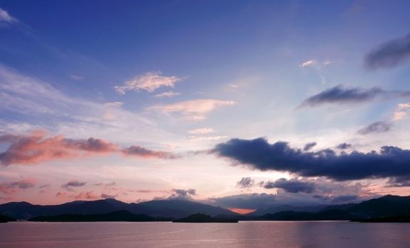 mountain, cloud, gradient sky and the ocean at sunset