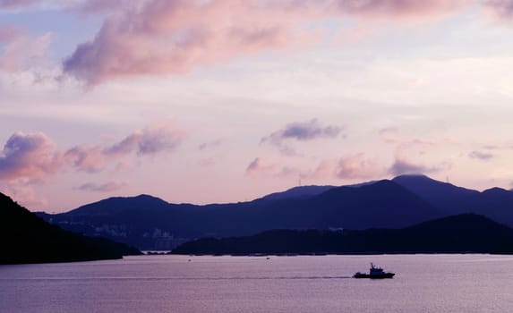 mountain, sky, boat on the sea at sunset