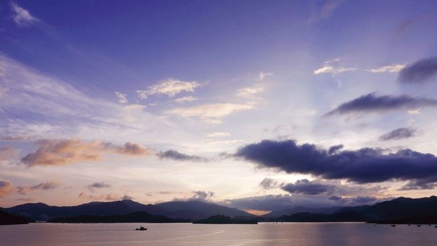 mountain, cloudscape sky, boat on the sea at sunset