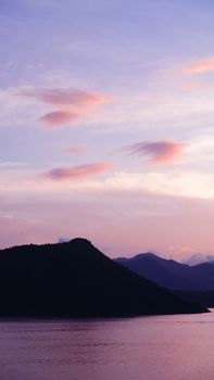 Vertical mountain, cloud and the ocean at sunset