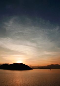 Vertical mountain, ocean, cloud and the gradient sky at sunset