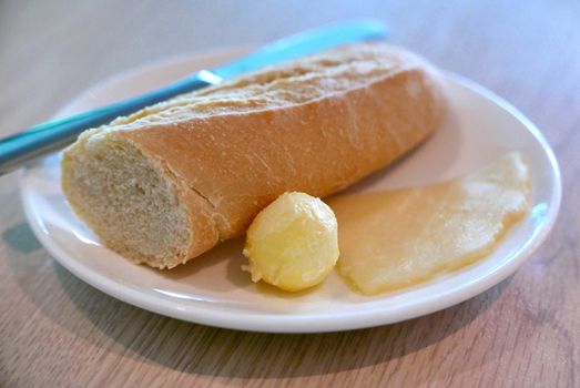 Breakfast meal bread, cheese and butter on the wooden table