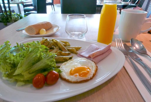 Hotel breakfast set, orange juice on the wooden table 