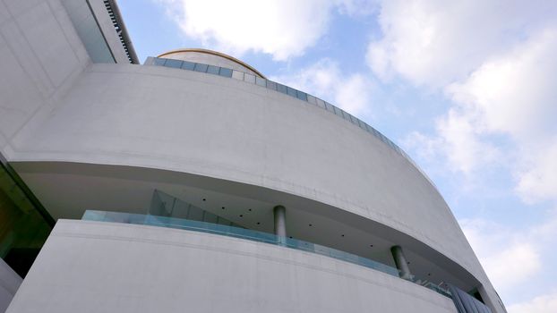 The exterior white wall of the exhibition building with blue sky