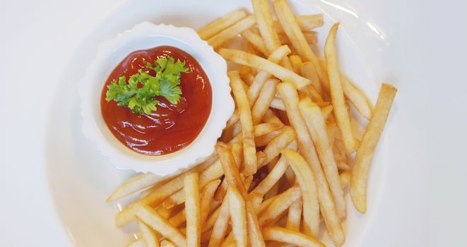 french fries fast food on white dish on table with ketchup