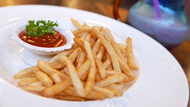 french fries fast food on white dish on table with ketchup