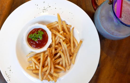 french fries fast food on white dish on the table with ketchup