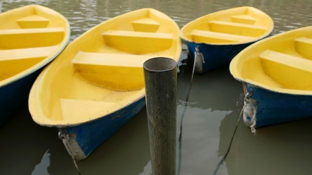 Old blue and yellow recreation boat on the lake 