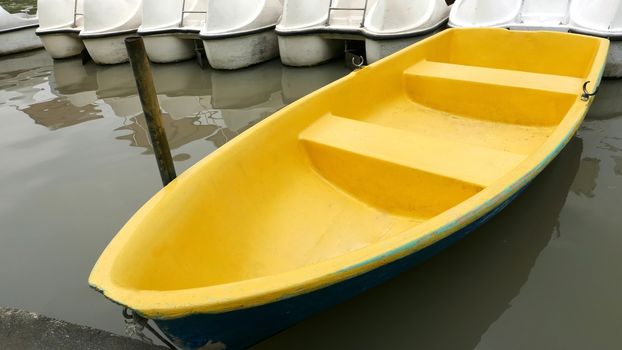 Old blue and yellow recreation boat on the lake 