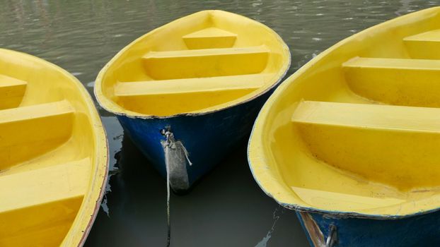 Old blue and yellow recreation boat on the lake 