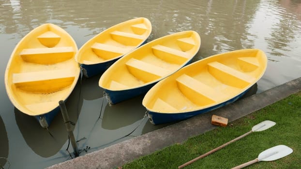 Old blue and yellow recreation boat on the lake 