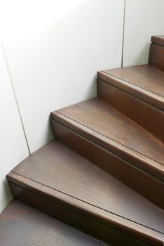 Closeup wooden curve staircase in the building