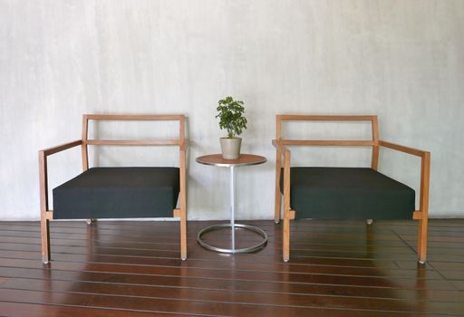 Outdoor furniture chair and coffee table near the wall