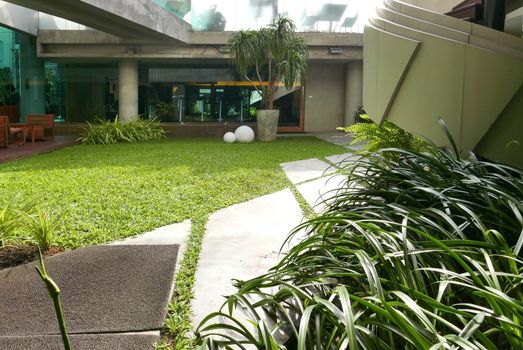 outdoor wooden furniture, backyard and modern curve staircase outside the building