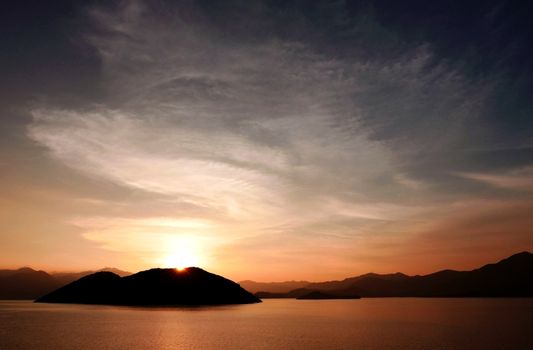 Mountain, ocean, cloud and the gradient sky at sunset