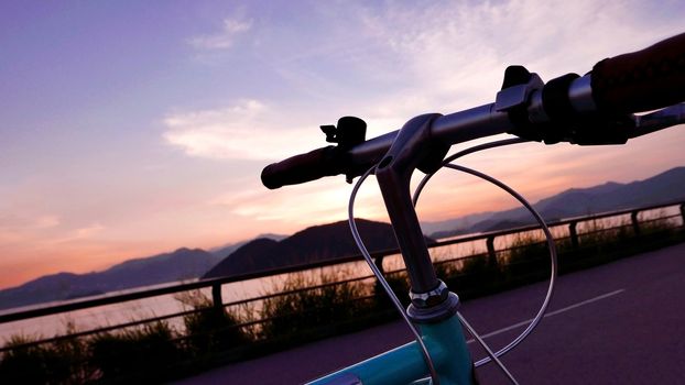 The head of retro bicycle and the frame silhouette at the sunset