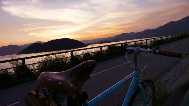 The part of retro bicycle and the frame silhouette at the sunset