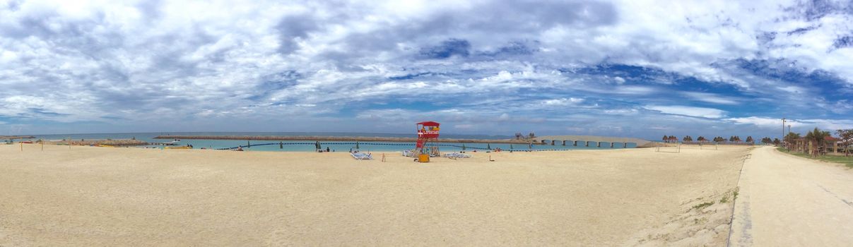 Panorama view Okinawa beach, lifeguard station, white cloud and sea