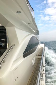 The side wooden hallway of white yacht and the blue sky