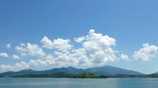 Green mountain, lake, blue sky and the white cloud