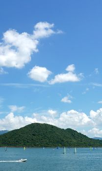 Vertical water sport windsurfing, blue sky and the white cloud