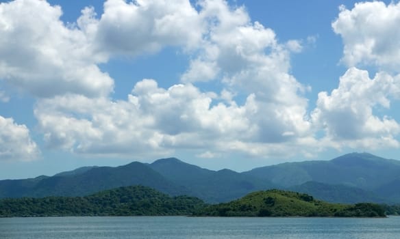 Green mountain, lake, blue sky and the white cloud