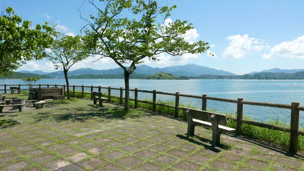 Outdoor wooden fence, bench, mountain and the blue sky