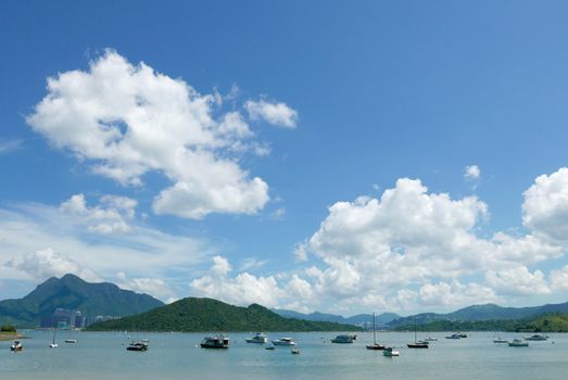 Motorboat, lake, mountain and the blue sky