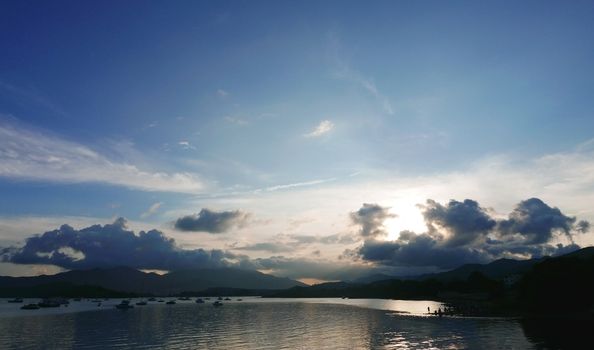 Motorboat, lake, mountain and the cloudscape