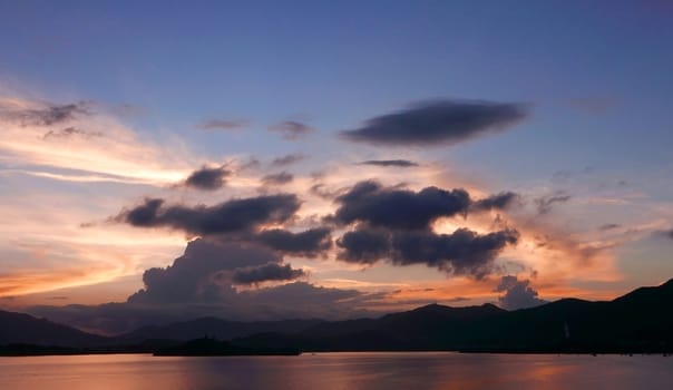 mountain, cloudscape, dramatic sky and ocean at sunset