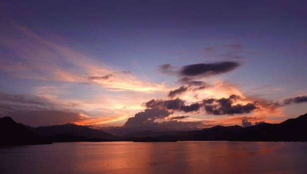 Mountain, cloudscape, dramatic gradient sky and ocean at sunset
