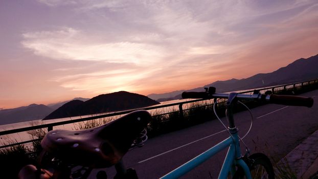 The part of retro bicycle and the frame silhouette at the sunset