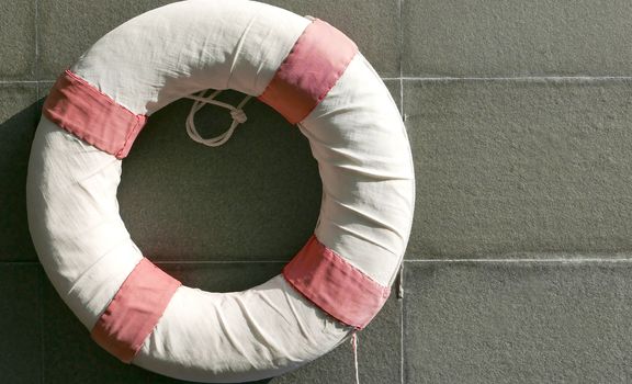 Red and white lifesaver near the swimming pool