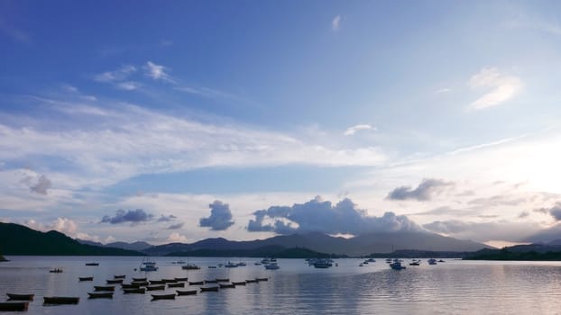 Boat, lake, mountain, blue sky and the clouds