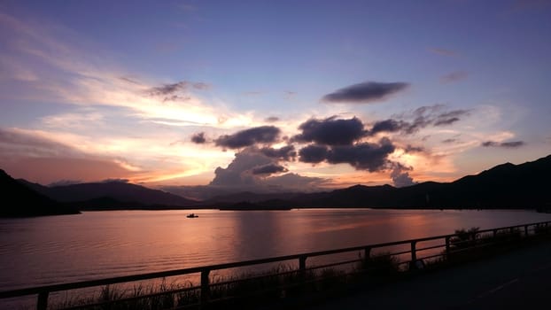 The silhouette of mountain, ocean and the dramatic cloud at sunset