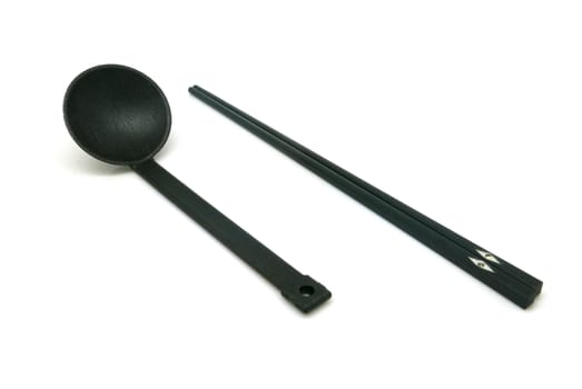 Black spoon and chopsticks isolated on white background