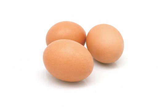 Three eggs with shadow on white background