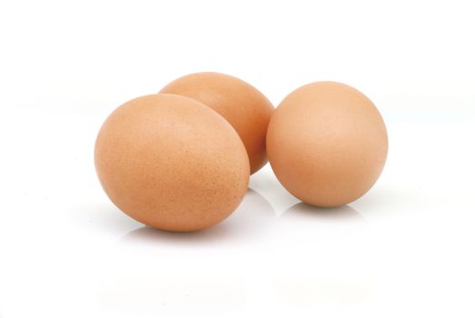 Three eggs with shadow on white background