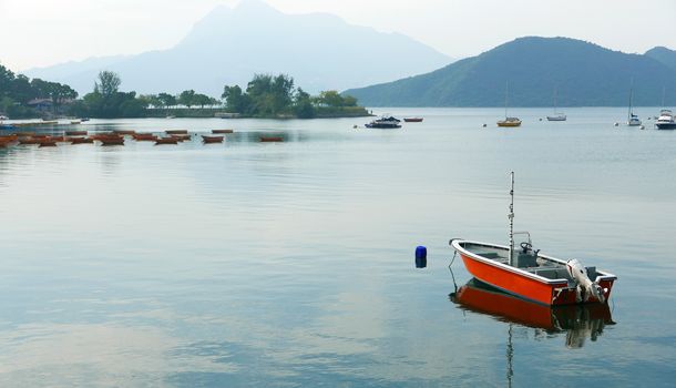 Speedboat, lake and blue sky with reflection shadow