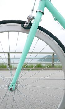 part of mint green retro bicycle and rim closeup