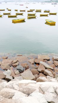 fishing boats on the lake near rock wall