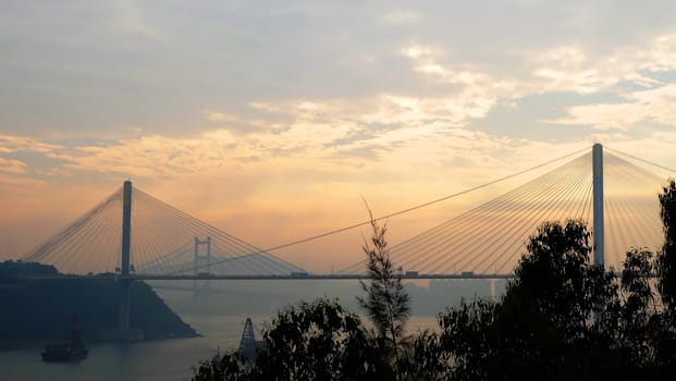 The silhouette of Hong Kong highway bridge building before sunset