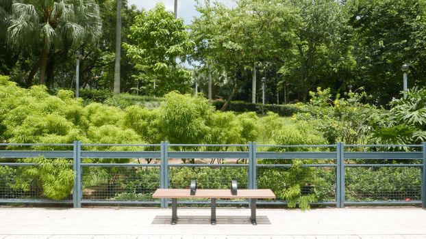 Outdoor wooden bench with their tree shadow are in the park