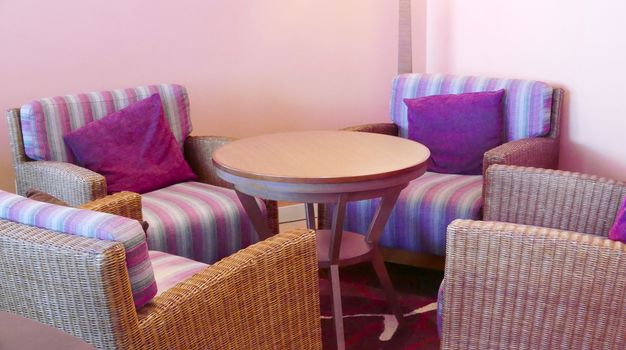 Cafe indoor furnitures with purple cushions