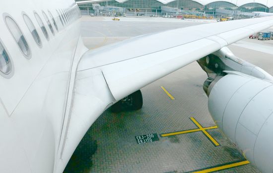 closeup airplane wing and engine in airport