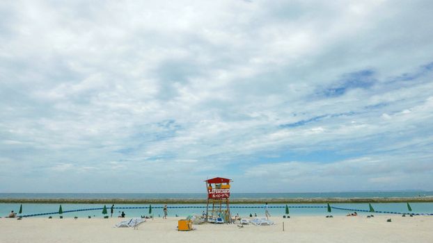 Red lifeguard stand and chair in the beach