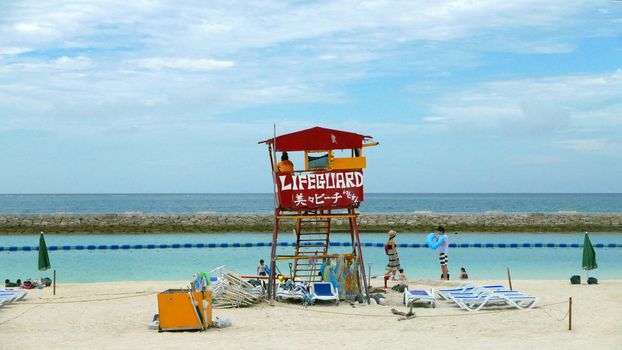 Red lifeguard stand and chair in the beach