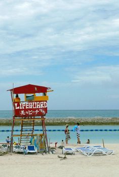 Red lifeguard stand and chair in the beach