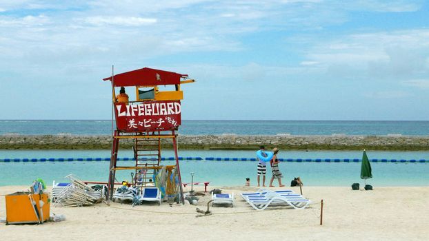 Red lifeguard stand and chair in the beach