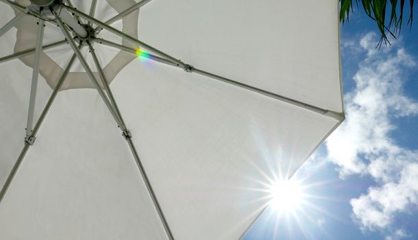 White suntanning umbrella and sunlight